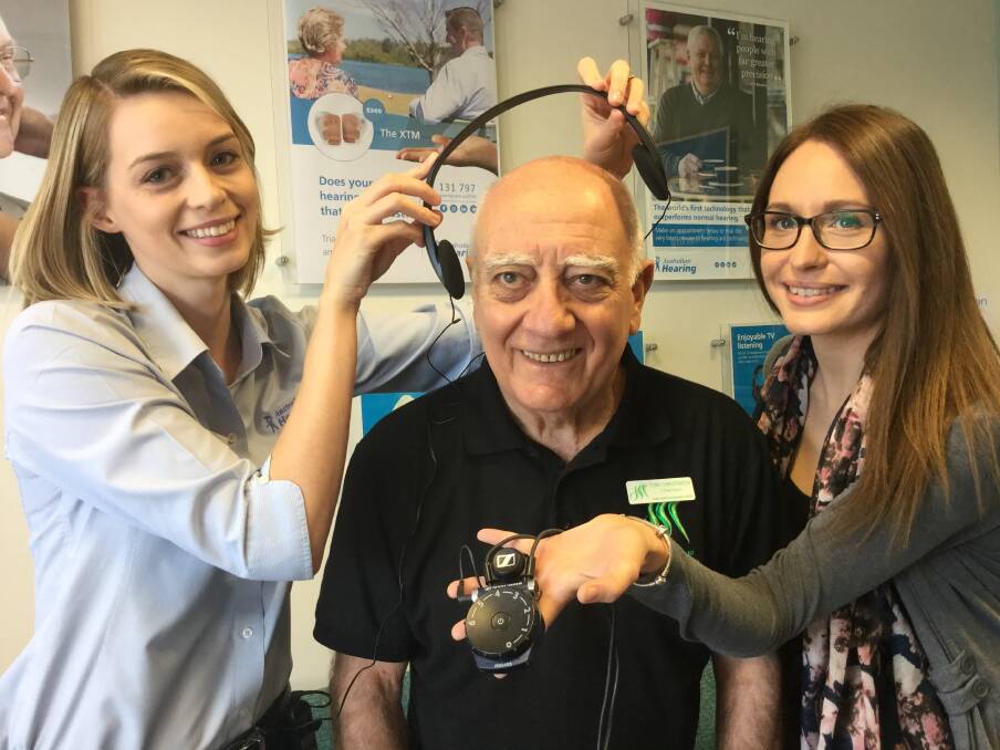 LISTEN UP: Australian Hearing staff members Caitlin Knapper and Kate Thomae with Redlands resident Tony Christensen. Photo: Supplied

