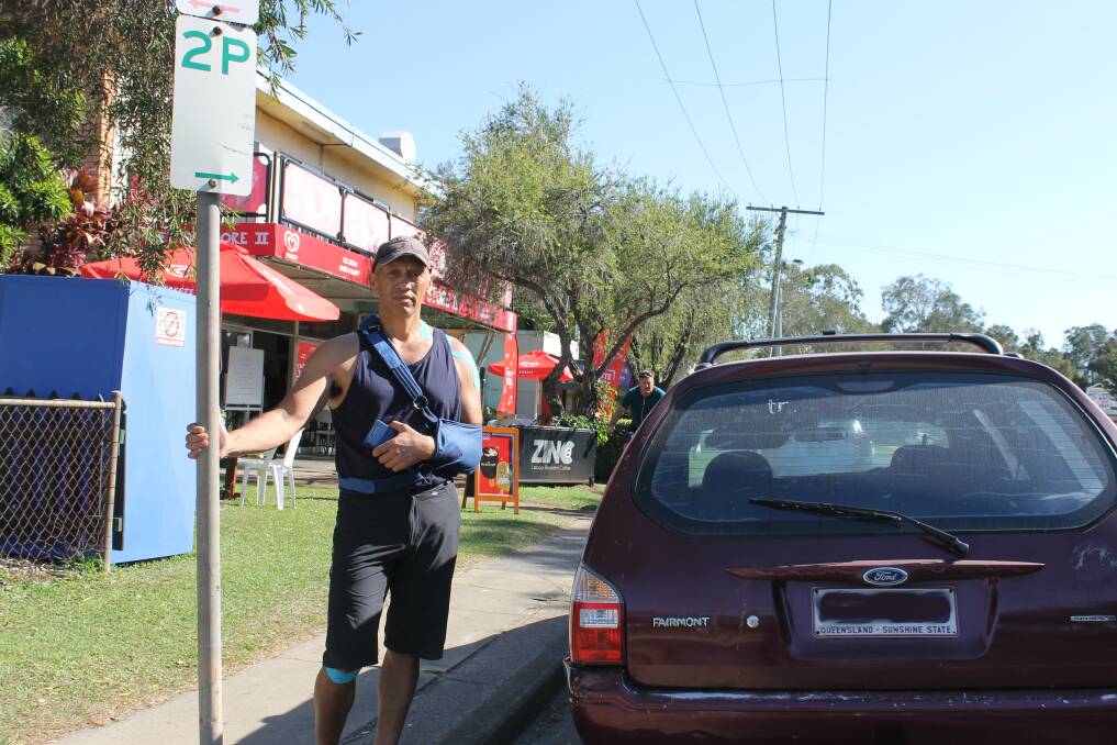 FRUSTRATED: Redland Bay cafe and store owner James Nohokau stands next to a car that had been parked outside his business for more than 72 hours. Photo: Cheryl Goodenough