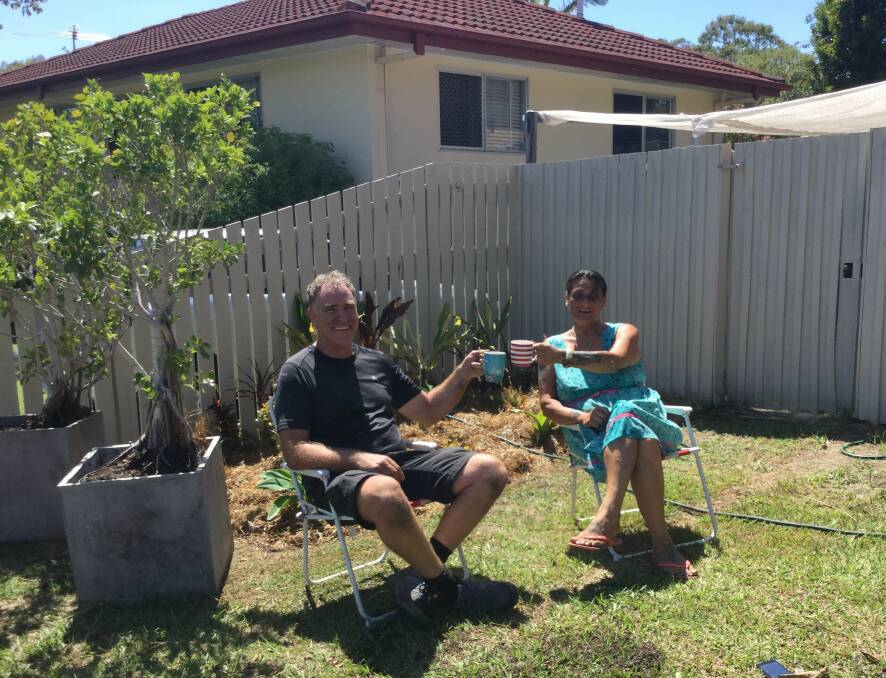AFTER THE HARD WORK: David and Natalie enjoy a cuppa after some hard work in the garden. The two linked up through Help Me With It. Photo: Supplied