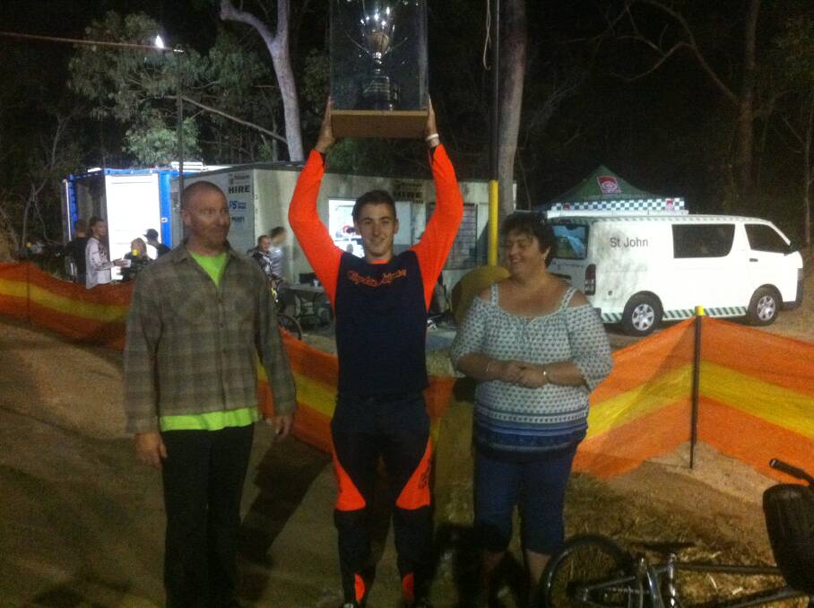 WINNER: Bradley Game of Wanneroo BMX Club in Western Australia lifts up the Max Haley Trophy. He is pictured with Redlands BMX Club president Gary Larsen and Max Haley's daughter Kellie Haley Chapman. 