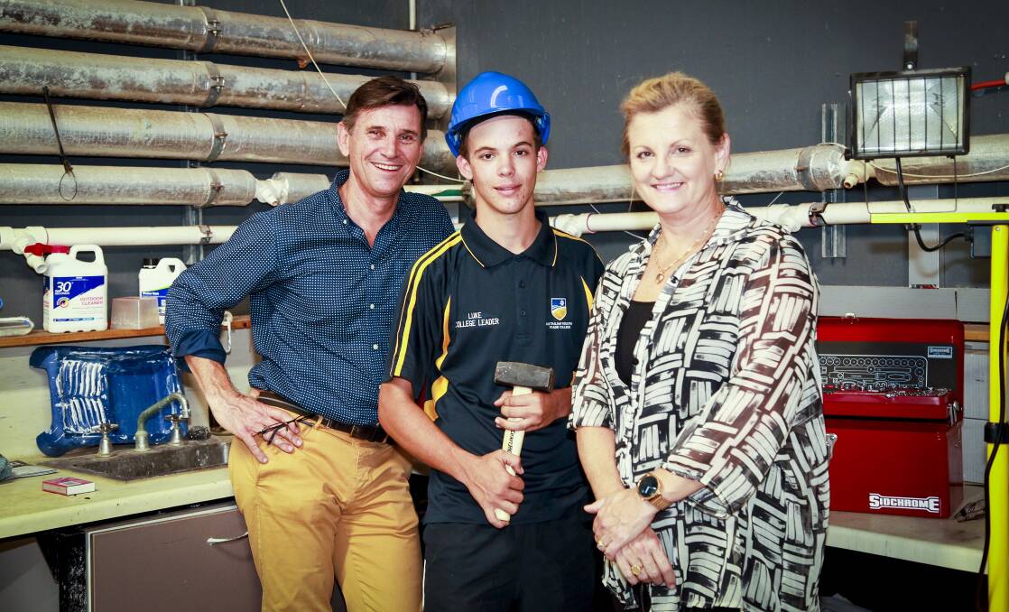 MILESTONE: Australian Industry Trade College chief executive officer Mark Hands celebrates the college's first year in the Redlands with student Lucas Kerr and Redland City mayor Karen Williams. Photo: Supplied
