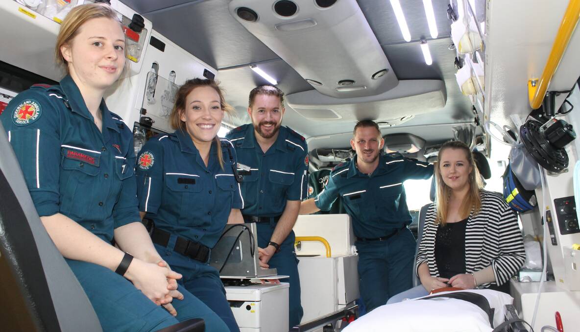 REUNION: Advanced care paramedics Lara King, Pascale Giroul and Andy McClure with extended care paramedic Tim Noonan show Imogen Donaghy around the ambulance that transported her to hospital. Photo: Cheryl Goodenough