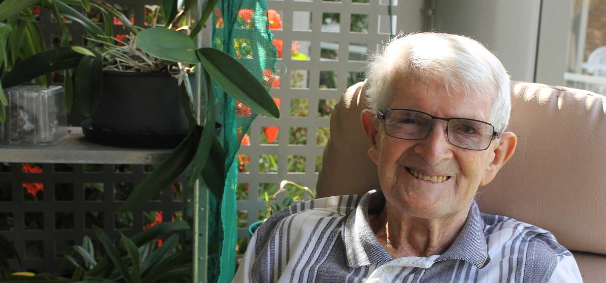 CENTENARIAN: Lake Sherrin resident George Rush is all smiles about celebrating his 100th birthday. The nearby orchids are his passion. Photo: Cheryl Goodenough