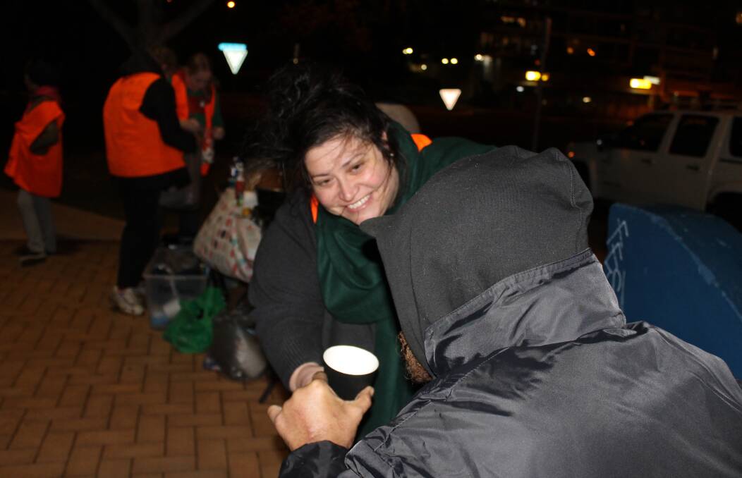 SHOWING COMPASSION: Lewis, a homeless man who uses a wheelchair, receives a warm cup of soup from Night Ninjas founder Alix Russo. Photo: Cheryl Goodenough
