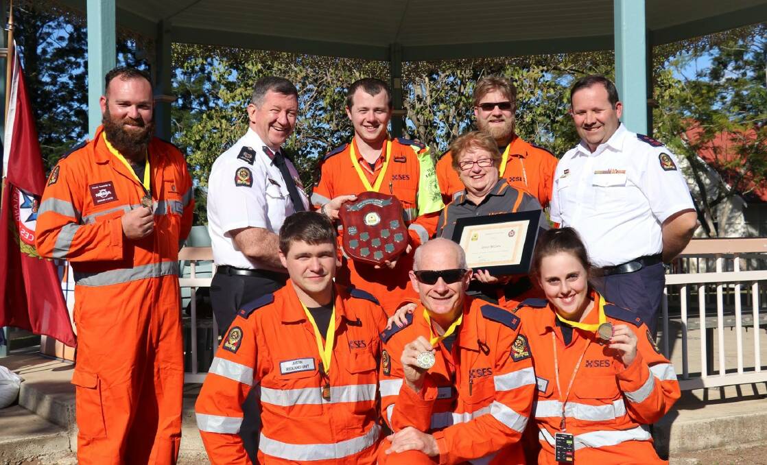 WINNERS: Redland SES members Justin Kirkby (front), Tim Willis and Steph Samuels and back (in orange) Joel Muraca, team leader Corey Armstrong, team manager Jenny Brown and Tristan Hardwick with SES Assistant Commissioner Peter Jeffrey (back, second left), and acting local controller Peter Gould.