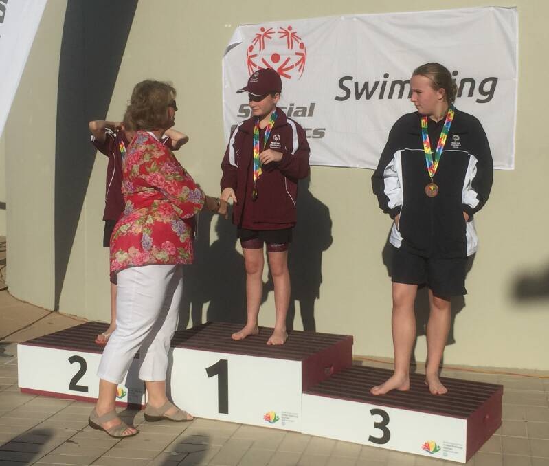 ON THE PODIUM: Rylee Grier-Stralow is awarded a gold medal for her swimming at the Junior National Games. Photo: Supplied