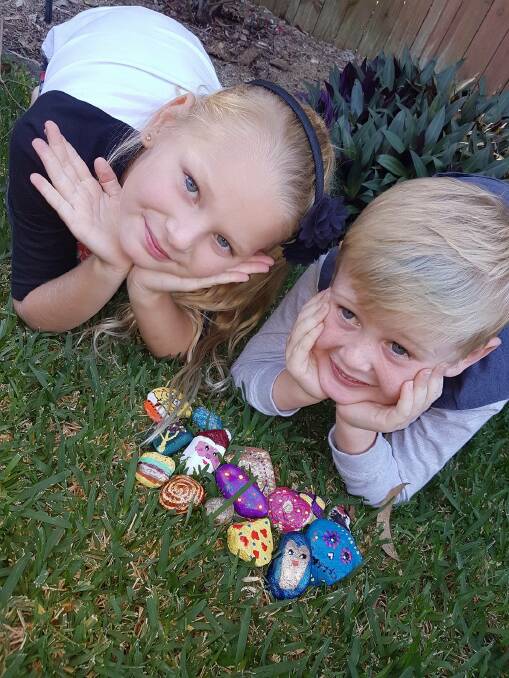CREATIVE FUN: Lily Hovell, 8, and Mason Hovell, 5, of Thornlands enjoy creating colourful rocks to hide in Redlands parks. Photo: Supplied