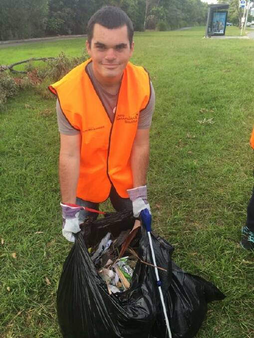VOLUNTEER: Redland Bay Victoria Point Lions Club member Brett Petersons during the clean-up. Photo: Supplied 
