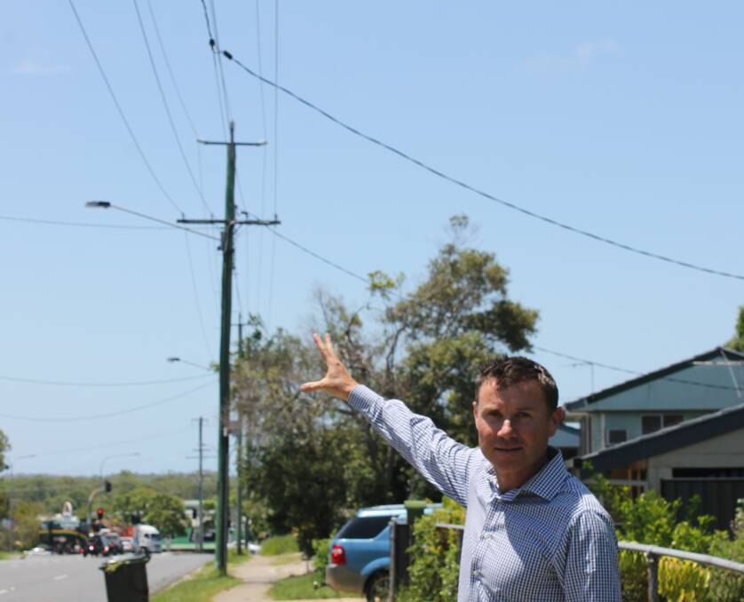 NBN: MP Andrew Laming gestures towards pre-existing pay-television cables being used to deliver the NBN to most of Capalaba. Photo: Cheryl Goodenough