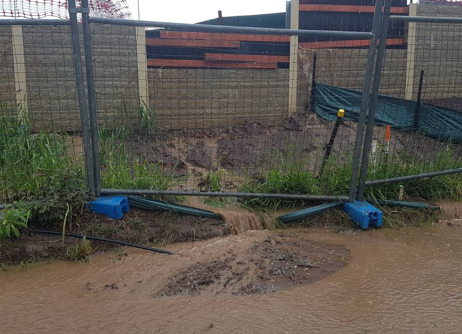 FLOODING: Water gushes from the retaining wall onto Dale Rogers' property in Thornlands on Sunday. Photo: Supplied