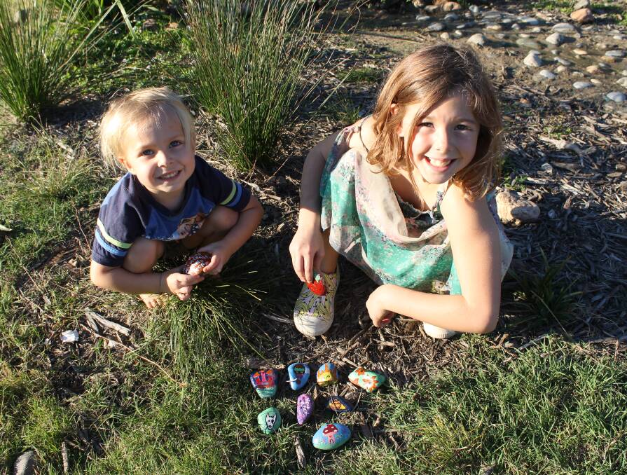 READY TO HIDE: Emrys Savvas, 3, and Abbey Spencer, 8, of Mount Cotton, get ready to hide their rocks. Photo: Cheryl Goodenough