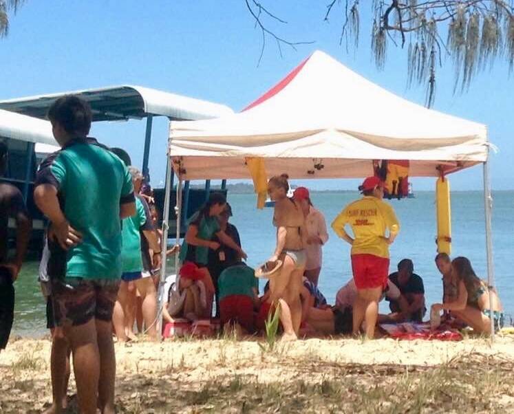 RESPONSE: Coochiemudlo Island Surf Life Saving Club members attend to a man who was injured on Sunday. Photo: Supplied