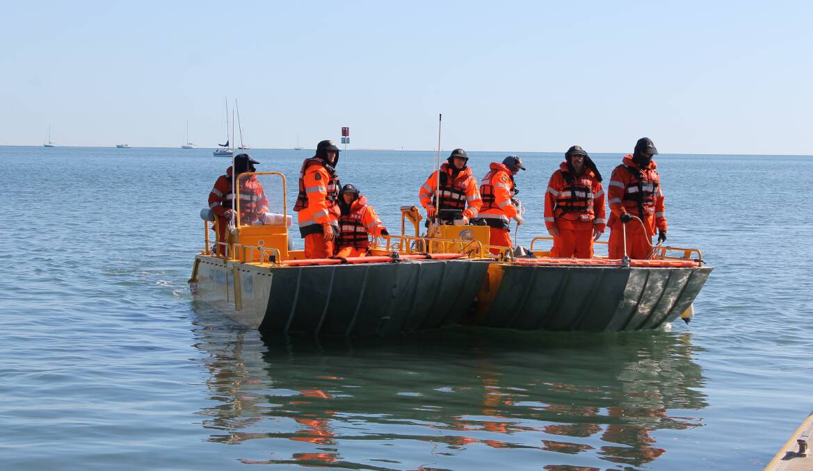WORKING TOGETHER: Redland SES volunteers use dual control to come towards a pontoon in Victoria Point while conducting training. Photo: Cheryl Goodenough