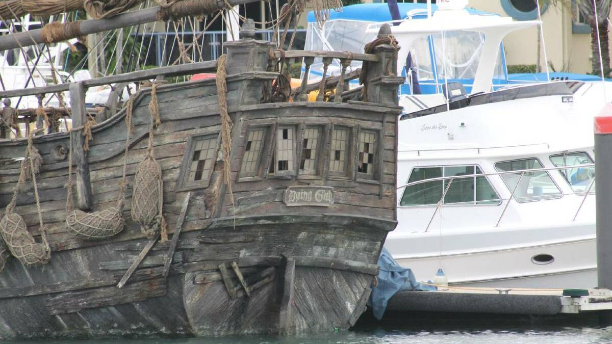The covers come off the pirate ship in Raby Bay Harbour revealing its name as Dying Gull.