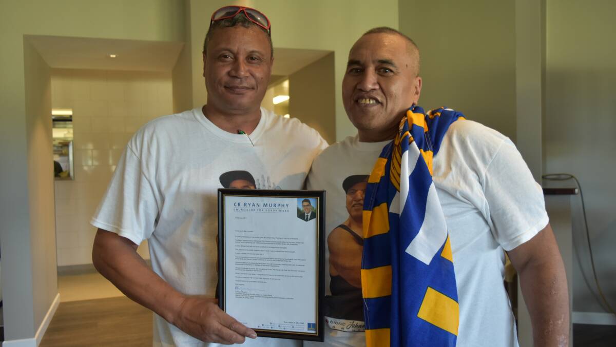 Wynnum's Mike Iafeta with Alexandra Hills' Johaan Kaa.  Mr Kaa was give the Flag of the City of Brisbane by Brisbane City councillor for Doboy Ward, Ryan Murphy.