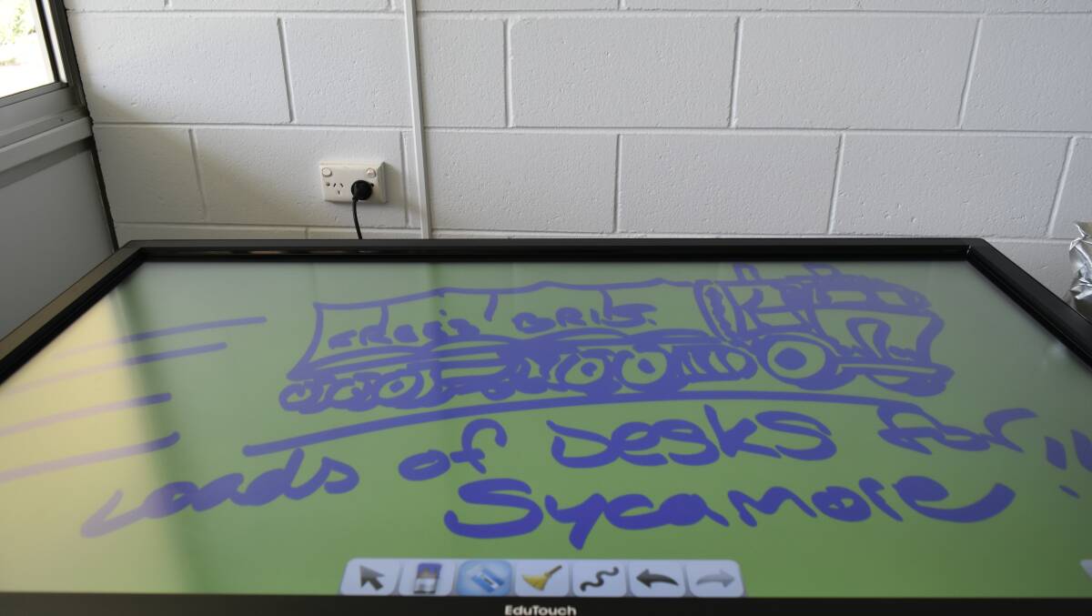 VISUAL LEARNERS: New equipment at The Sycamore School includes touch-sensitive interactive boards.
