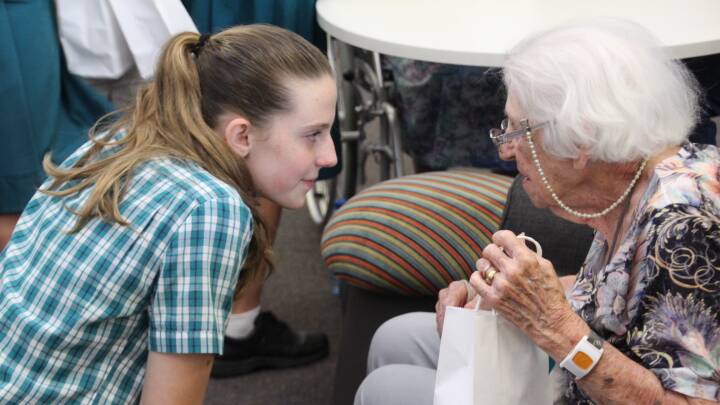 Sarah Wilson, who also submitted a prize winning entry, crouched down to talk with resident Edna Cox during a visit to Cleveland's Freedom Aged Care.
