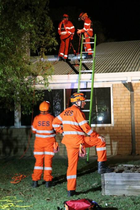 ROOF PROBLEMS: About 46 calls for help were made in the aftermath storm activity on Friday November 26. SES volunteers are pictured attending to a home damaged.