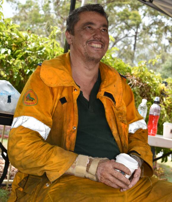 GREAT RESPONSE: Rural Fire Service volunteer Bill Sim, of Russell Island, takes a break from battling the blazes on his second shift in as many days. Photo: Hannah Baker