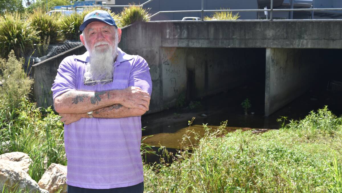 DAILY STROLL: Milton Ludlow, of Capalaba, in front of the watercourse he saw was polluted on Wednesday.