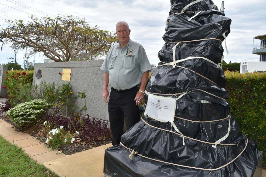 UNDER WRAPS: Redlands RSL Sub Branch president Alan Harcourt stands next to the nurse and wounded digger statue which will be unveiled on Remembrance Day, November 11. Photo: Hannah Baker