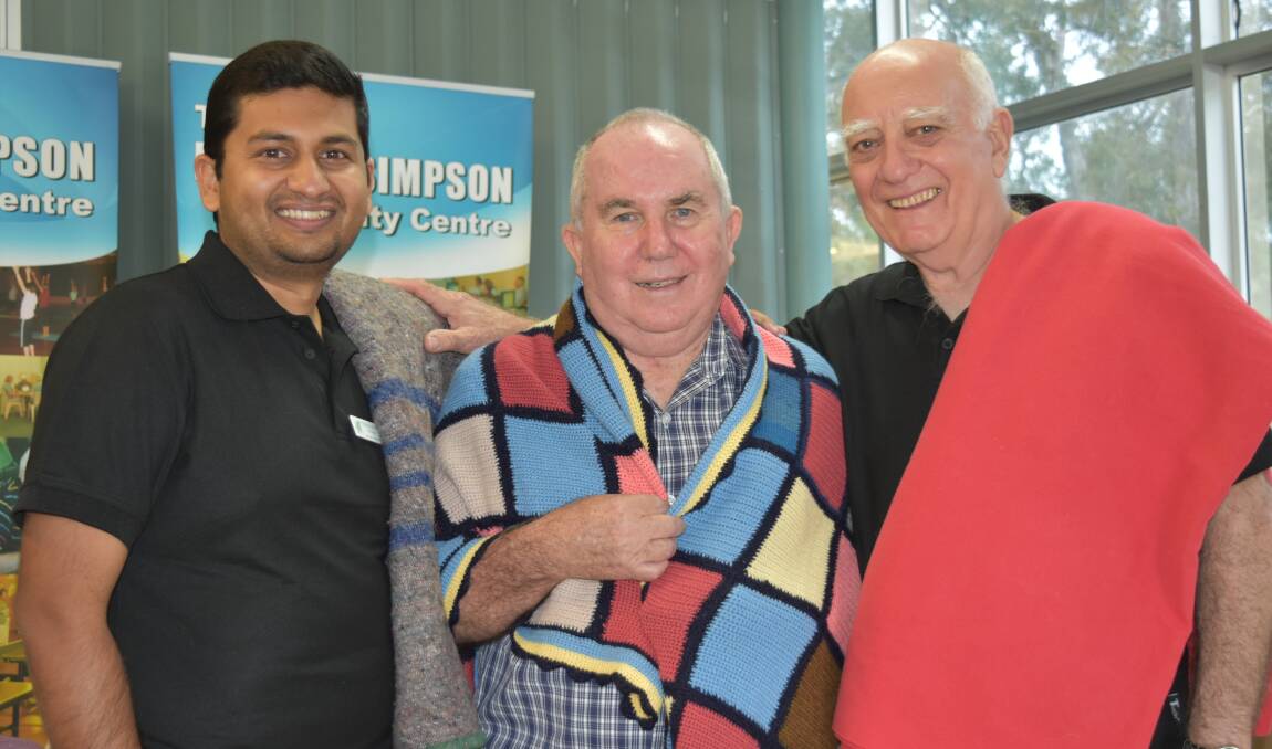 BLANKET WANTED: Donald Simpson Community Centre's Thomas Jithin with former manager Ernie Harrison and Tony Christinson. Photo: Hannah Baker
