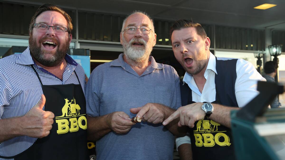 PROS: Maclay Island cook Bruce Macdonald picks up some barbecuing tips from Shane Jacobson and Manu Feildel at Yatala Drive In at the launch of the film The Barbecue.