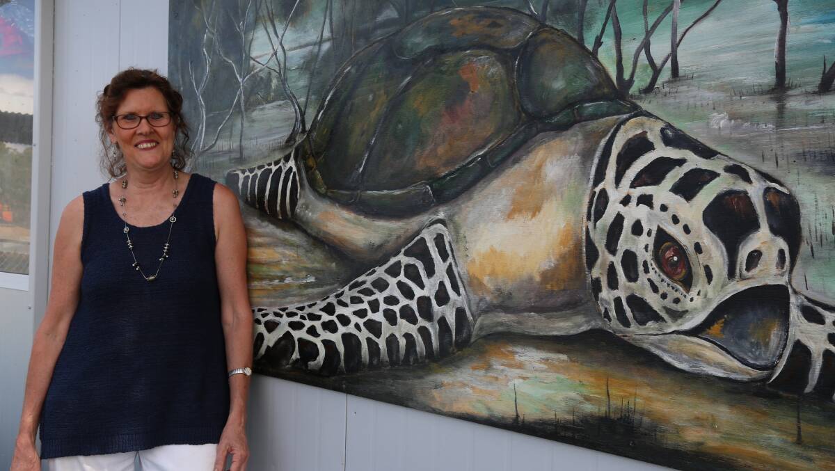TURTLE: Suzanne Pike with the mural painted by Darren Goleby at the Macleay Island ferry terminal.