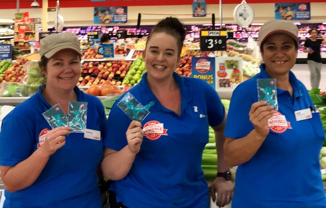 TEAL: Summa Fraser, Chloe Youngs and Jean Jlassi got into the spirit raising funds for ovarian cancer during a teal day at Cleveland Coles on February 15.
