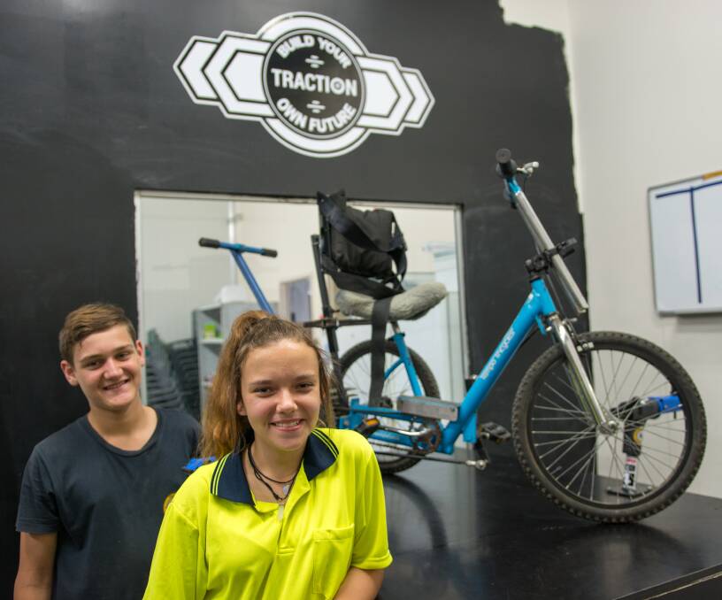 TRACTION: Kulan Khafagi and Bailey Jackson work with bicycles through the Traction program.