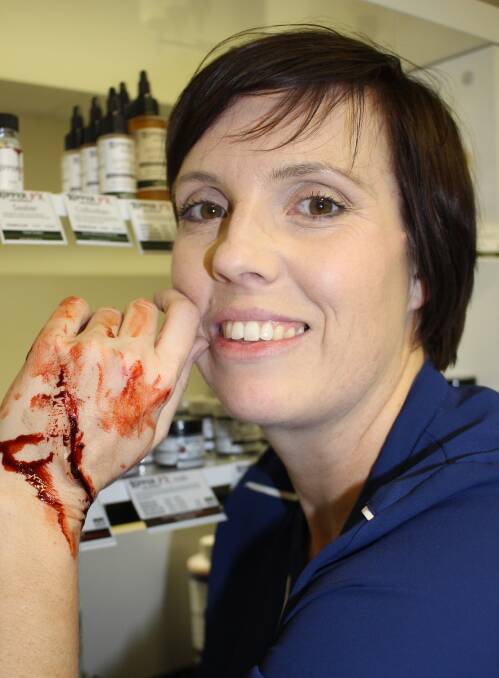 MAKE UP: Nicola Richards is more interested in making the hand look appropriately bloodied than creating glamour make up, having left the British film industry to create a special effects make up brand.  Photo: Linda Muller