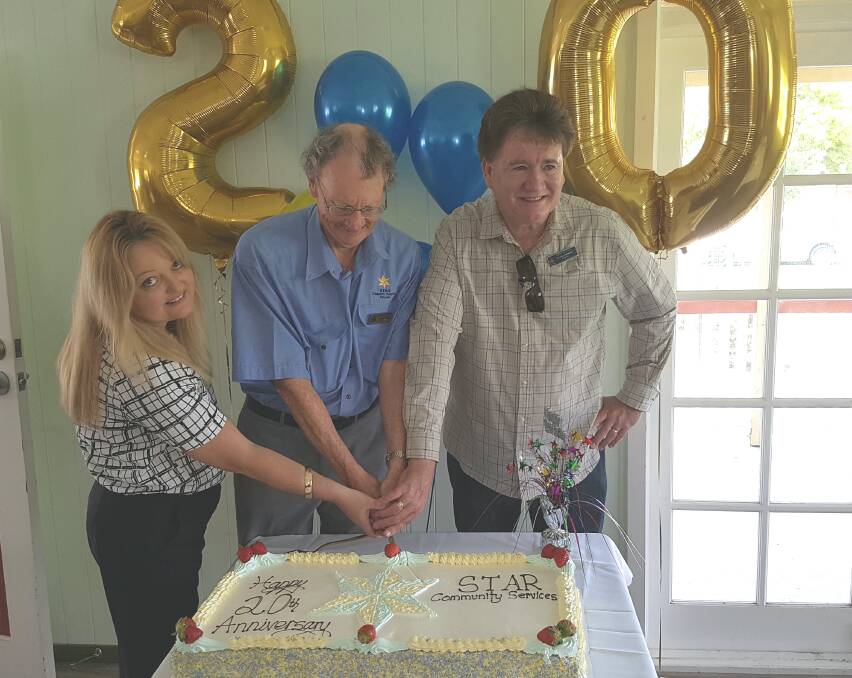 CAKE: Cutting the cake for the 20th anniversary of Star Transport are  STAR General Manager Patsy Wilshire, STAR Chairman Rob Spencer and Cr Lance Hewlett.