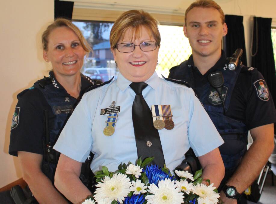 HONOUR: Senior Constable Gayle Edgely, officer in charge of Cleveland station Janelle Harm and Constable Jake Porter remember the fallen.