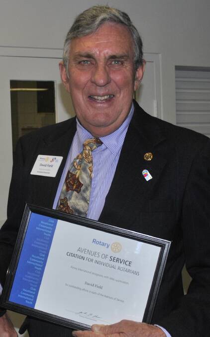 AWARD: David Field receives his award as a Paul Harris Fellow sapphires at Capalaba Rotary Club's changeover dinner.