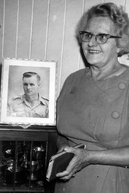 DIARY: Passage to Pusan heroine Thelma Healy at home after returning from her life mission to visit South Korea in front of a picture of her lost soldier son Vincent and holding her travel diary which was basis for the book Passage to Pusan.







