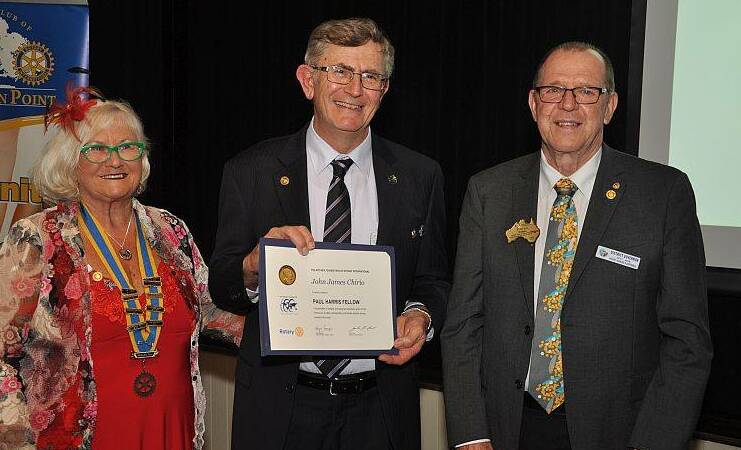 AWARD: Incoming Rotary Wellington Point President Lorraine Hooker presents John
Chirio with his Paul Harris award, with  District Governor Elect Elwyn Hodges.  Photo: Dennis Head.