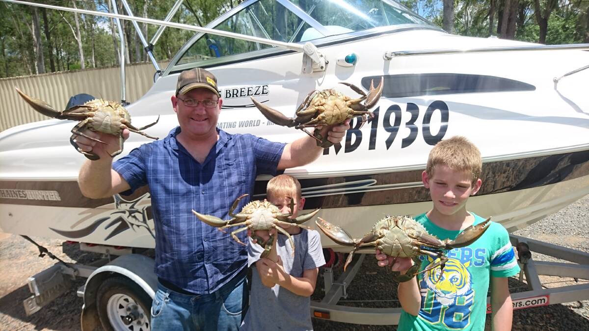 Michael, Jaymie and Corbin Kutschkau with mud crabs caught on the Gold Coast.