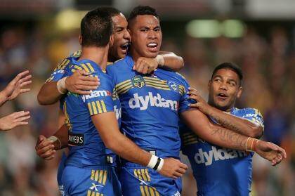 Making a name for himself: Eels winger John Folau celebrates after scoring the first of his two tries. Photo: Mark Metcalfe