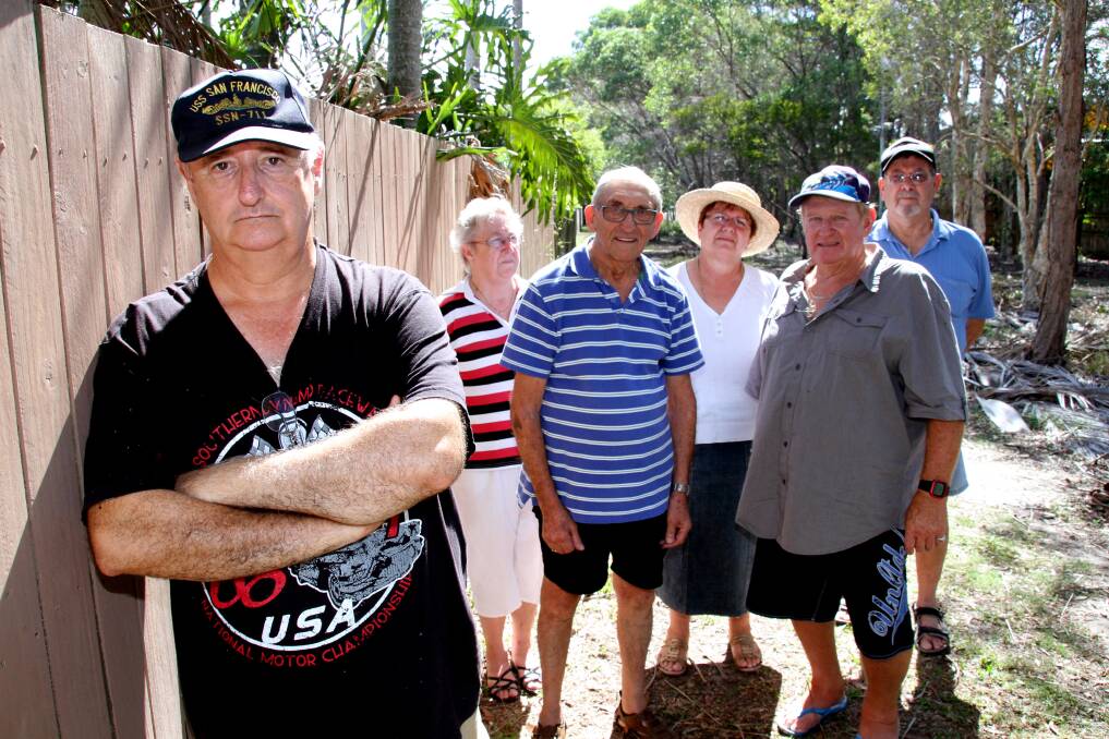 Concerned residents adjoining a parcel of land between Sycamore Parade and the Victoria Point Town Centre Shopping Centre that is the subject of a possible handback to the developer. Pictured are (from left) Martin Sealy, Dorn Sullivan, George Speight, Maria Sealy, Ray Dunn and Clarence Cooke. 
Photo by Chris McCormack