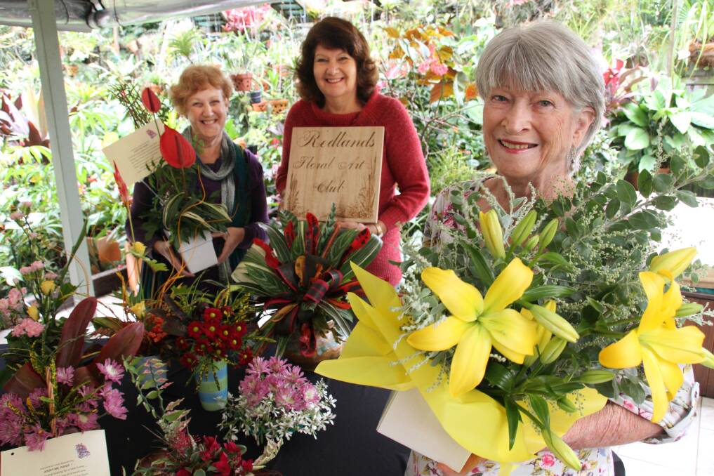 Redland Floral Art group secretary Lynda Reynolds, treasurer Val Decker and president Irene Corbett are making floral bouquets to give away.  
Photo by Chris McCormack