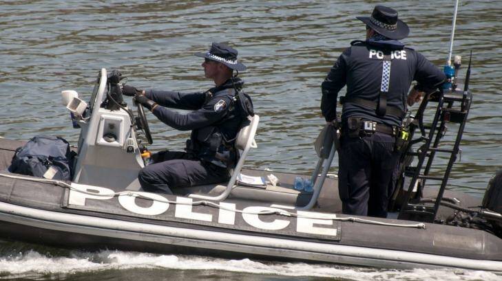 Water police are among the officers searching the Brisbane River at Hamilton for a swimmer thought to be in trouble. Photo: Robert Shakespeare