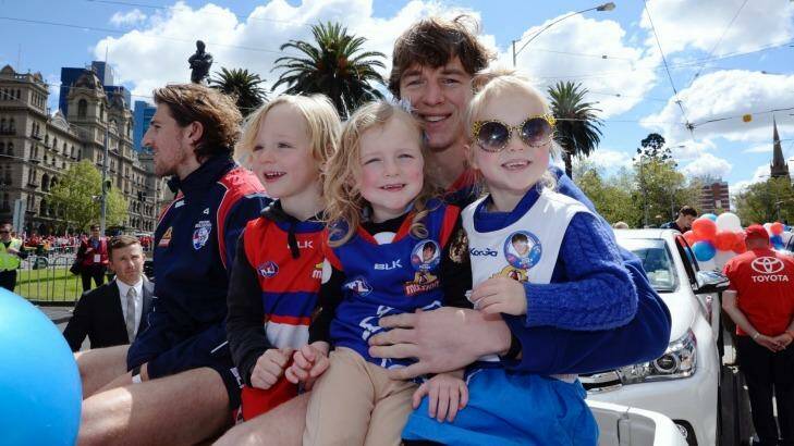 The Bulldogs' Liam Picken with his children at the parade. Photo: Justin McManus