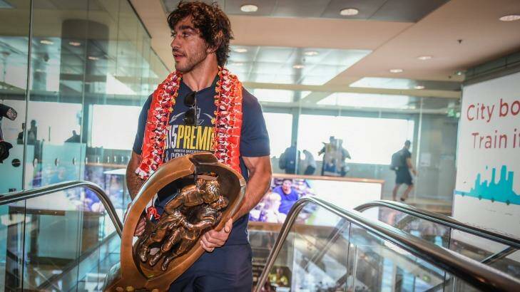 Spoils of victory: Johnathan Thurston prepares to take the NRL premiership trophy home to Townsville for the first time. Photo: Brendan Esposito