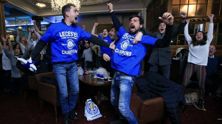 Leicester City fans celebrate in Leicester after Chelsea's Eden Hazard scores the equalising goal against Tottenham Hotspur, delivering the Foxes the Premier League championship. Photo: Jonathan Brady