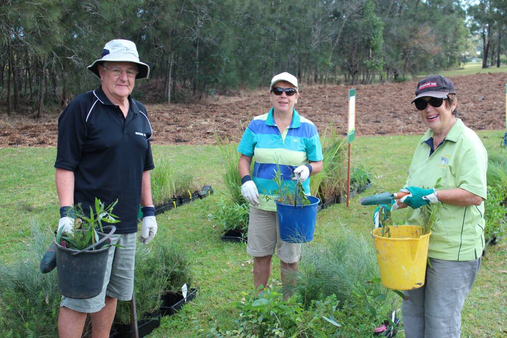 Carole Clark, of Birkdale, with Wendy and Michael Smith, from New Zealand, helped with the local planting. Photos by Redlands IndigiScapes