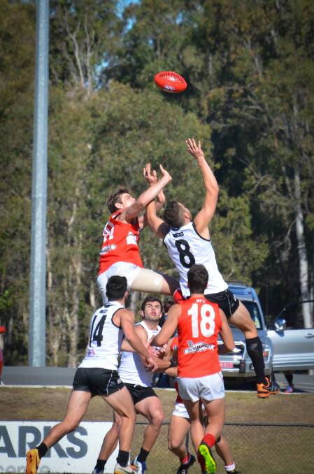 Redland Bombers ruckman Paul Hunter (51) climbs high on his Southport opponent Keiran Brennan (8). 
Photo by Highflyer Images
