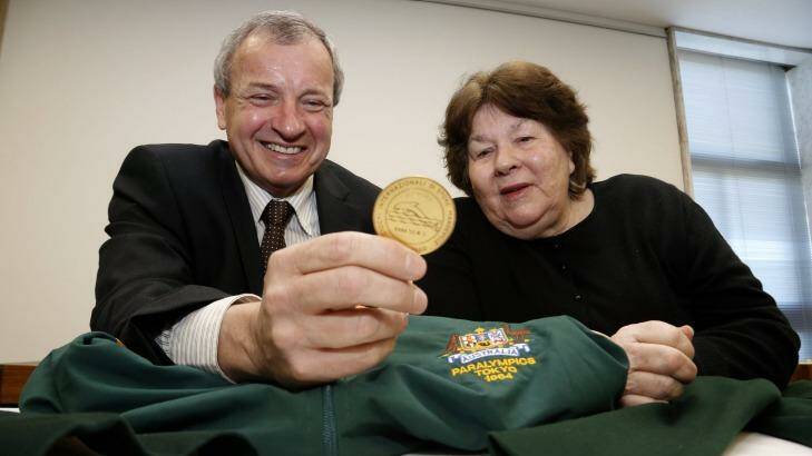 Greg Hartung looks at the uniforms and medals donated to the Australian Paralympic Committee by Australia's first female Paralympian Daphne Hilton in 2012.  Photo: Jeffrey Chan 