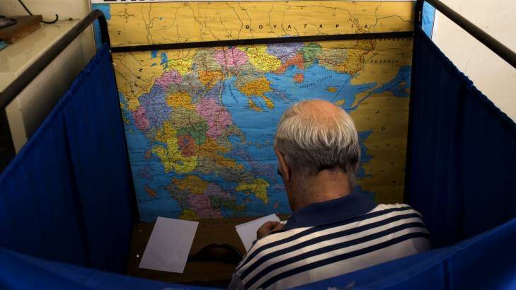 A man casts his vote on Sunday. Photo: Emilio Morenatti