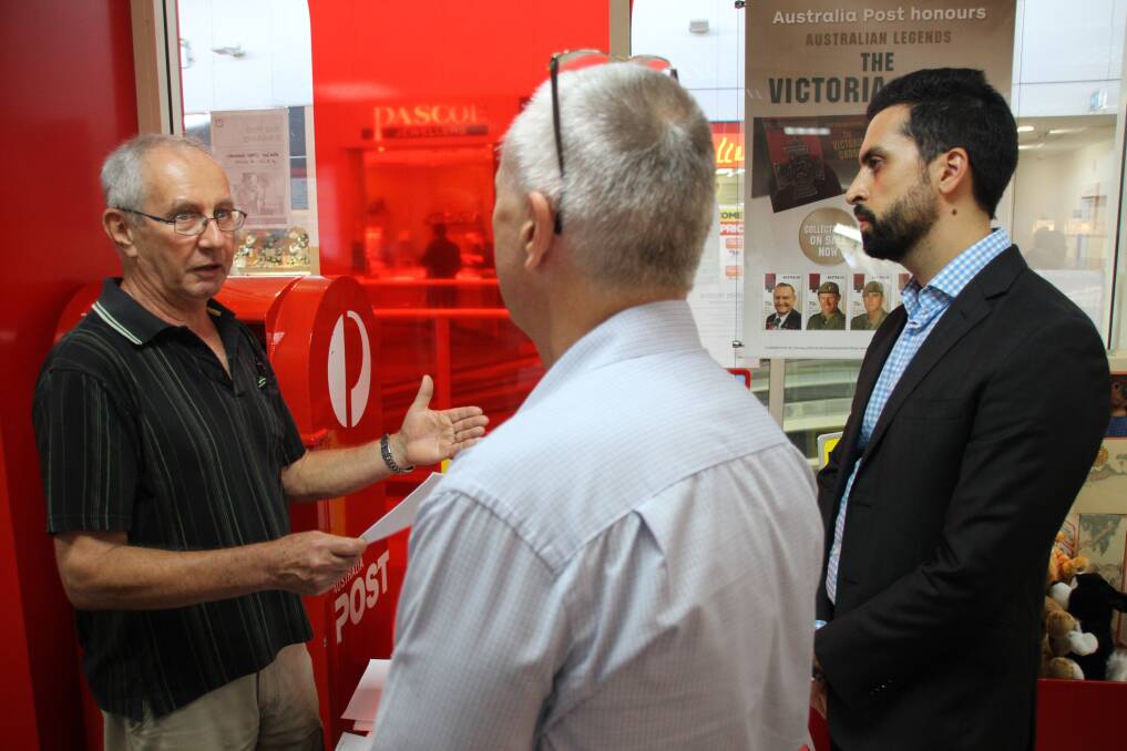 Roy Materne, of Thornlands, speaks to Australia Post area manager metro south operations Mark Horton and network planning Queensland retail services manager Robert Nucifora at Cleveland Post Office during the meet the Australia Post reps day. 
 Photo by Chris McCormack