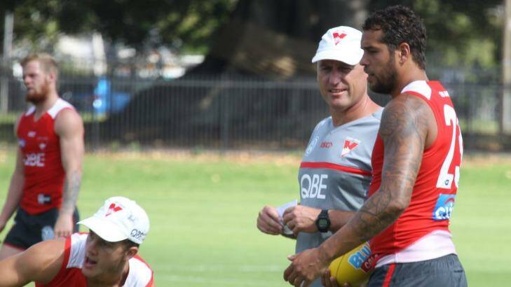 Private matters: Swans coach John Longmire chats with his superstar forward Buddy Franklin.  Photo: Peter Rae